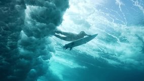 Underwater view of surfer dive under wave breaking over coral reef. Oahu north shore famous action sports destination. travel in Hawaii. slow motion 4k. - Powered by Shutterstock - Get 15% off with code: PIKWIZARD15