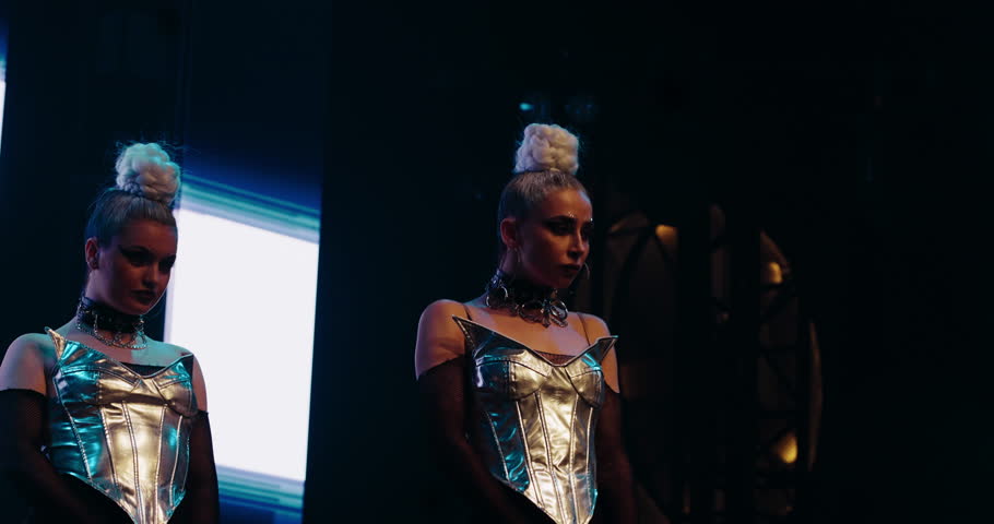 Backup Dancing And Woman Singer Performing On Stage In Red Lights Of Contemporary Illumination