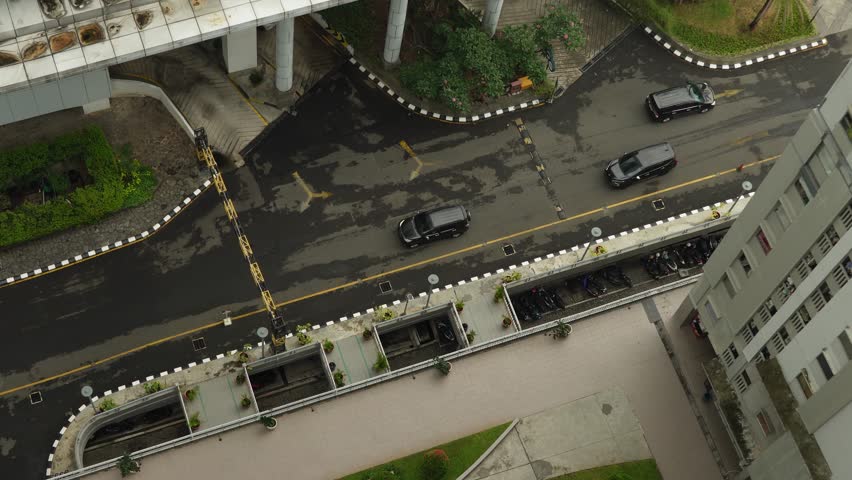 Aerial view of Cars are exiting the multi-level parking lot of an apartment building in the Pluit area, North Jakarta, Indonesia