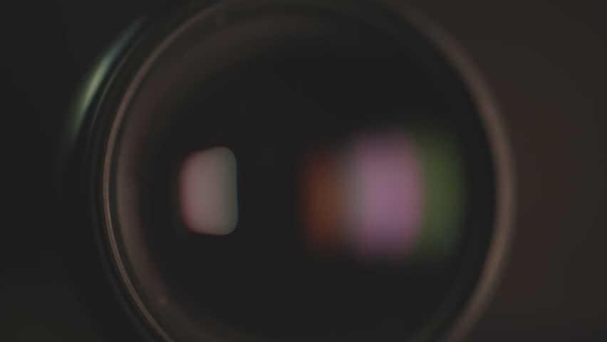 Macro photo showing the lights reflected in the camera lens.
