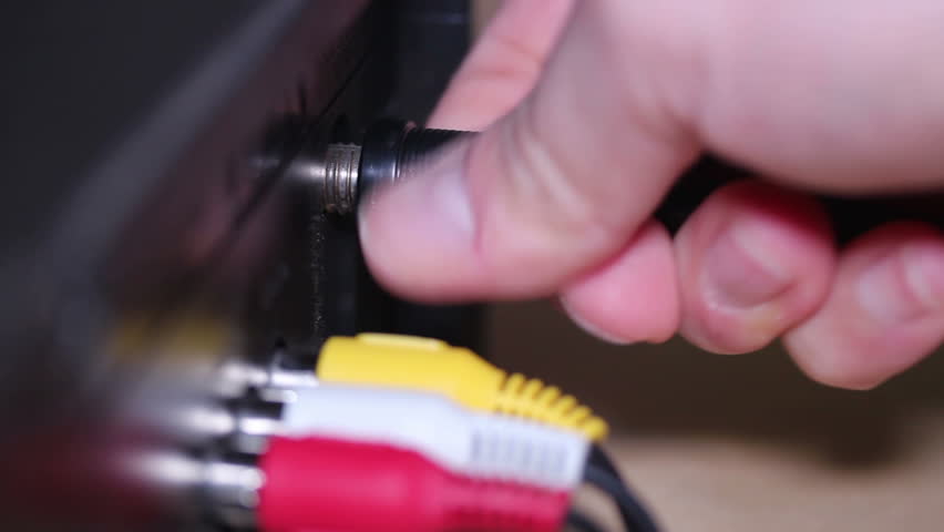Close-up shot of attaching and disconnecting a coaxial cable.