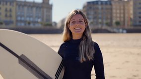 Portrait of a happy surfer woman at the beach. - Powered by Shutterstock - Get 15% off with code: PIKWIZARD15