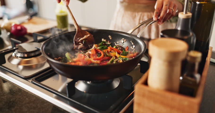 Stove, hands and person with vegetables for cooking, frying and preparation for healthy diet in kitchen. Culinary, female cook and above with food for staring, vegan and nutrition meal with peppers