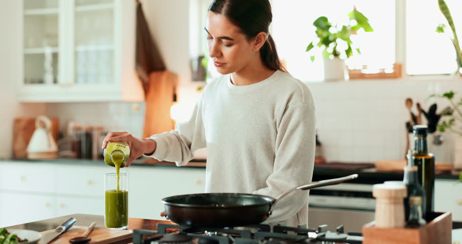 Woman, happy and smoothie in house for health, nutrition and breakfast in morning with cooking. Female person, smile and green healthy drink in kitchen for wellness, weight loss or detox with protein