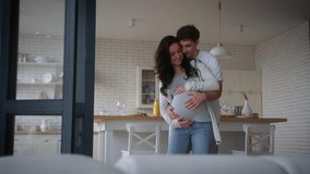 Happy pregnant couple dance calm at home enjoying pregnancy hugging cuddling touching belly talking medicine insurance health dancing moving man guy male father hug woman girl female mother bonding - Powered by Shutterstock - Get 15% off with code: PIKWIZARD15