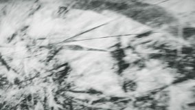 Top view of ice skating on frozen lake. Ice pond with thick ice with deep cracks, following shot. Vertical video - Powered by Shutterstock - Get 15% off with code: PIKWIZARD15