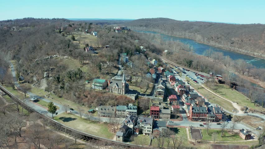 Aerial view of a small town nestled in a mountain valley, with scattered homes under a clear sky, Harpers Ferry West Virginia USA
