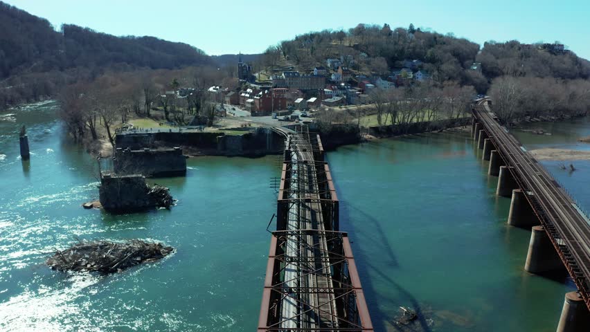 Harpers Ferry West Virginia USA, aerial dolly along train tracks to historic downtown overlooking the river