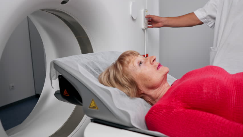 close up in a modern clinic in a white office, a drug for MRI examination of the brain of an elderly woman young doctor nearby