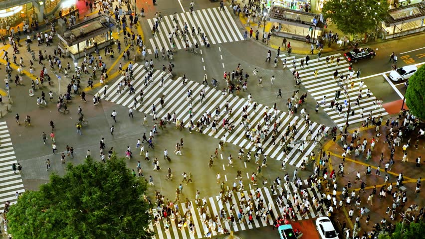 Looking down at thousands of people crossing the famous Shibuya crosswalk in Tokyo Japan