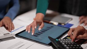 Businesswomen working together using digital tablet and calculator analyzing financial data on office desk - Powered by Shutterstock - Get 15% off with code: PIKWIZARD15
