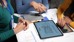 Businesswomen team is analyzing financial data on a digital tablet, having an animated discussion about the market trends - Powered by Shutterstock - Get 15% off with code: PIKWIZARD15