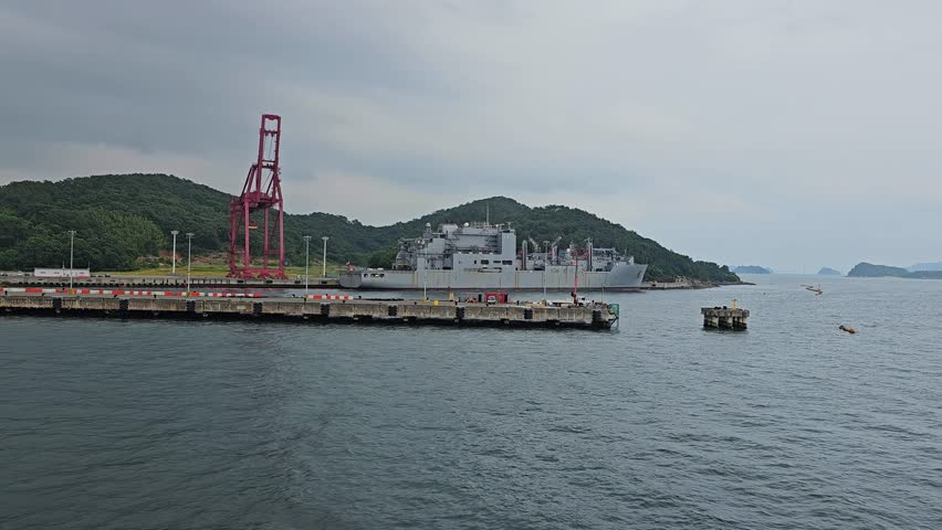 Warship Anchored On Busan Harbor Near Port Of Busan In South Korea. wide, parallax shot