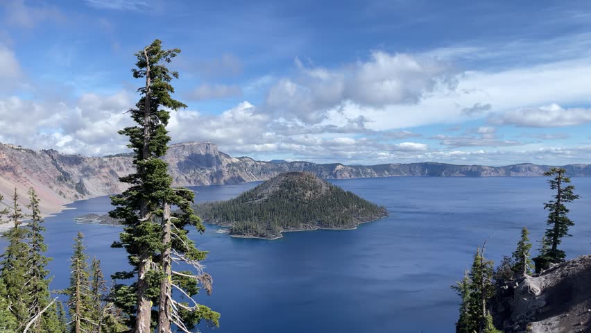 Time lapse of puffy clouds moving across the sky above Crater Lake in Oregon