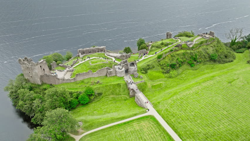 Aerial view of Urquhart Castle Large, ruined castle overlooking Loch Ness. The fortress situated on a headland, medial ruin in the Scottish Highlands laid out around two main enclosures on the shore.
