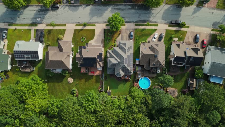 Top View Of Solar Panels Installed On Homes In A Luxury Residential Area Of Halifax, Nova Scotia, Showcasing The Push For Green Energy In The Community.