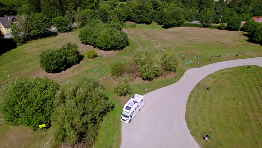 Aerial shot of a camping and recreational area nestled in vibrant, lush green surroundings.