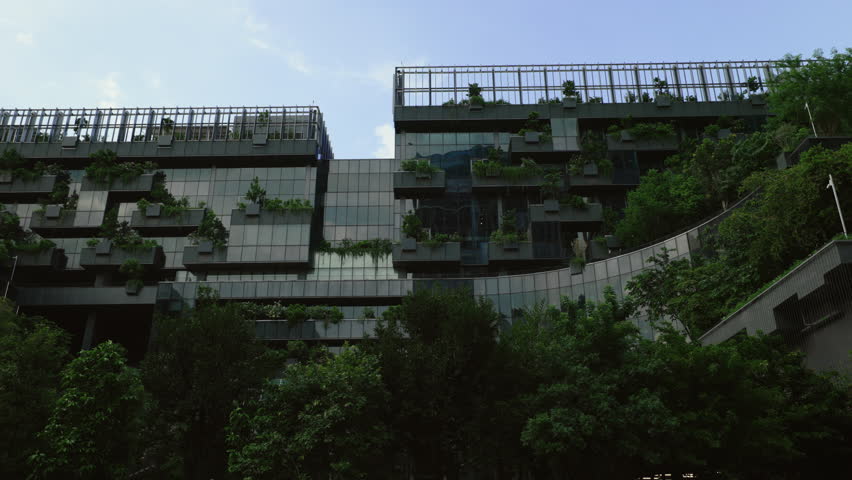 A contemporary building design featuring vertical gardens and abundant greenery integrated into the architecture, showcasing biophilic architecture and emphasizing ecological sustainability.