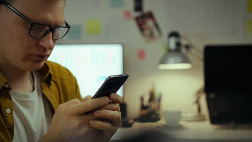 A future techie takes a break from classes, using a mobile gadget in dorm room. Next to the computer, young college student sits, interestedly studying the information on the screen of his smartphone
 - Powered by Shutterstock - Get 15% off with code: PIKWIZARD15