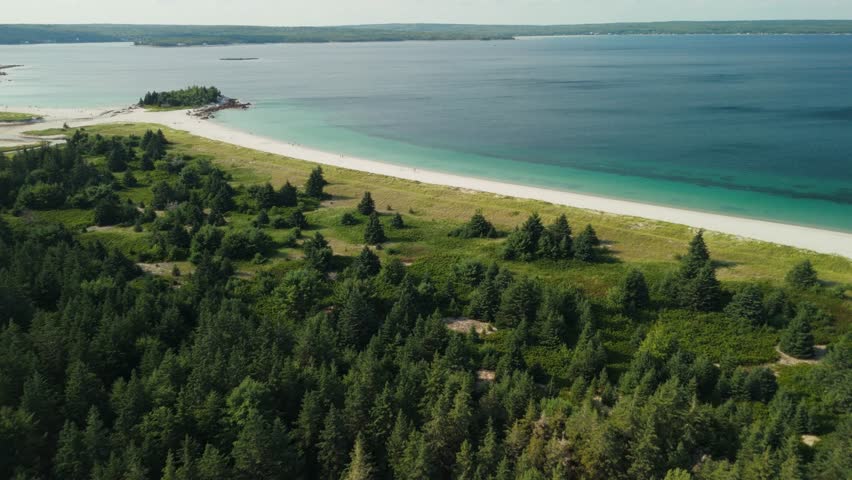 A Beautiful Drone Shot Captures The Golden Sunset Over Carters Beach In Nova Scotia, With Soft Waves Gently Washing Onto The Shoreline. Canada