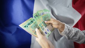 French flag background. Woman counting money euros. Credits, raising tariffs in EU Europe, traveling costs, financial concept. - Powered by Shutterstock - Get 15% off with code: PIKWIZARD15