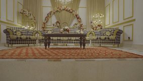 A beautifully decorated banquet hall featuring empty chairs, floral arrangements, and luxurious furnishings. Perfect for events, weddings, or celebrations in an opulent setting. - Powered by Shutterstock - Get 15% off with code: PIKWIZARD15