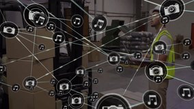 Using tablet, warehouse worker with connected devices and multimedia icons animation. Logistics, technology, digital, connectivity, communication, supply chain - Powered by Shutterstock - Get 15% off with code: PIKWIZARD15