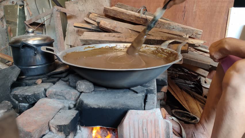 Cooking dodol, stirring dodol. Dodol is a traditional Indonesian cake made from sticky rice flour, coconut milk, and brown sugar.
