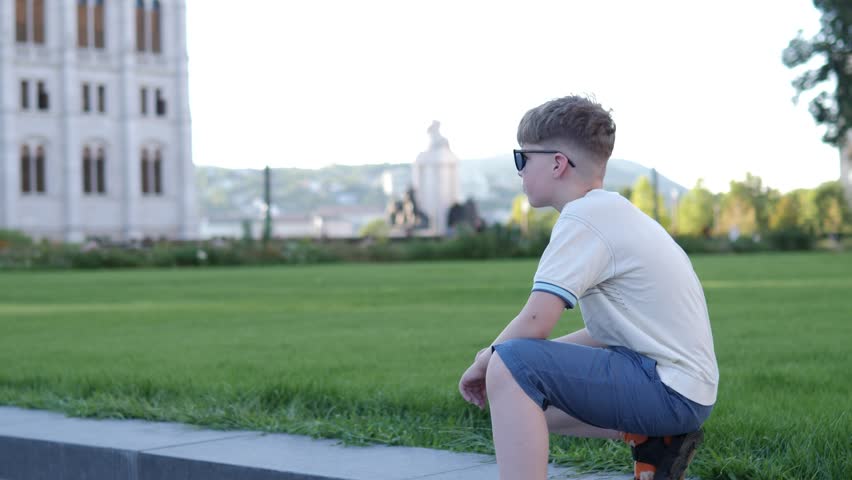 Child enjoying stroll through notable square in Budapest showcasing city elegant architecture and vibrant atmosphere. Little boy explore beautiful square in Budapest historical cultural significance.