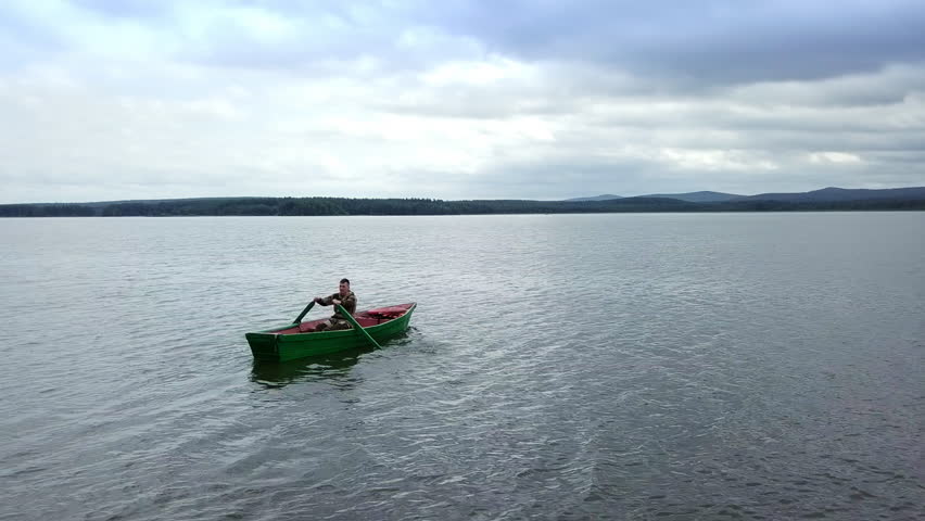 Enjoy the peaceful activity of kayaking on a serene lake, surrounded by natures tranquility. Stock Clip