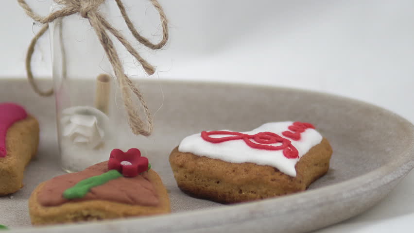 Colorful heart-shaped cookies in a plate served for a fancy party on a buffet table. Close up