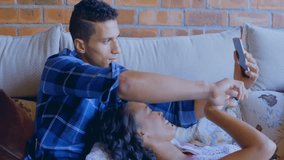 Couple relaxing on couch with financial data processing animation over them. Finance, technology, analysis, digital, home, investment - Powered by Shutterstock - Get 15% off with code: PIKWIZARD15