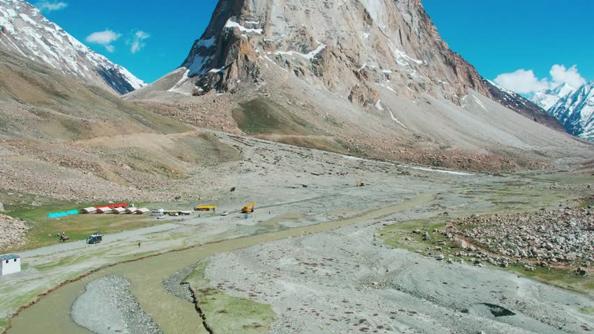 Aerial drone footage of snow covered mountains at Everest Base Camp in Nepal, highlighting the majestic Himalayan peaks, and rugged terrain during daytime