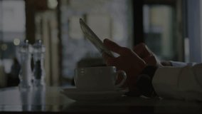 Holding smartphone, person with coffee cup over financial data processing animation. Technology, finance, mobile, business, digital, analysis - Powered by Shutterstock - Get 15% off with code: PIKWIZARD15