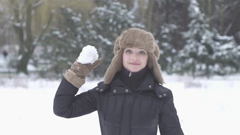 woman throws snowball hitting camera slow motion 1080 HD