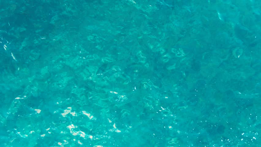 Aerial top view of the sea with a forward view of a rock. Kukuihoolua island