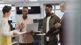 Binary code animation over diverse business team discussing documents in office. Technology, teamwork, collaboration, innovation, digital, meeting - Powered by Shutterstock - Get 15% off with code: PIKWIZARD15