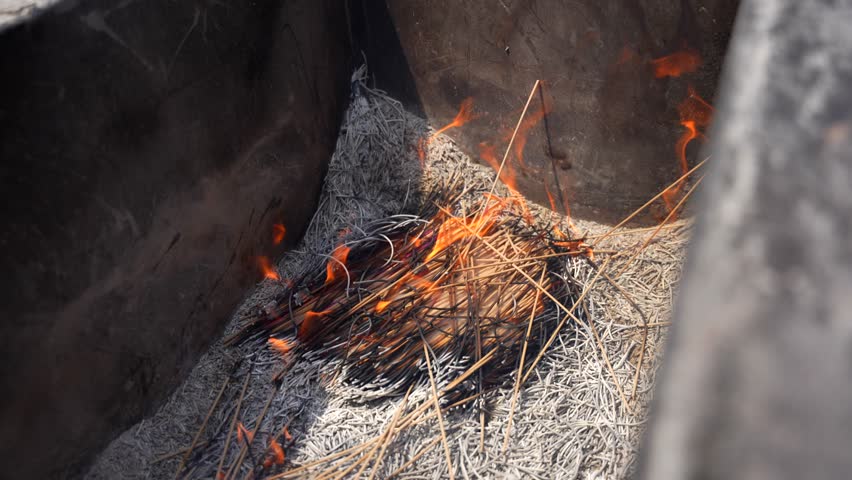 Small bonfire in incense burner as people add sticks at Lama Temple in Beijing, China