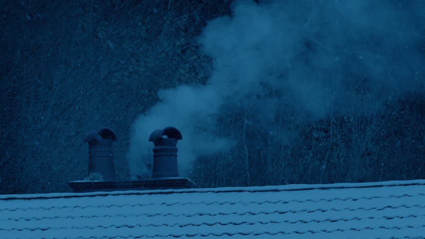 Snowing On House In Winter With Smoking Chimney