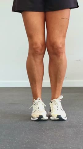 vertical close-up view of an elderly athlete’s legs while jumping rope during a cardiovascular workout at the gym. The focus is on the action and movement involved in the exercise