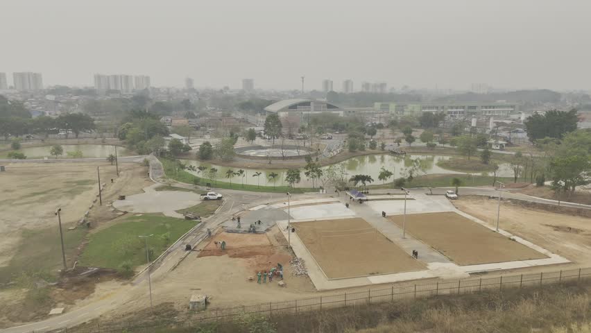 Drone flies north over Parque da Cidade on smokey day from wildfires in Porto Velho, Rondônia, Brazil