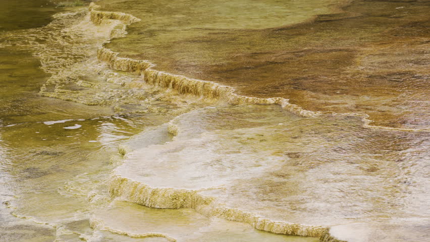 Cinematic shot of thermal mineral terrace at Mammoth Hot Spring in Yellowstone National Park, USA