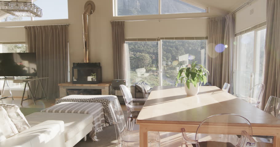 Panning shot of furnished living room home interior with view to mountainside, slow motion. Lounge, home, interior design, luxury, domestic life and lifestyle, unaltered.
