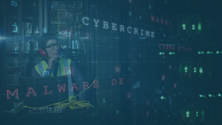 Cybersecurity terms animation over worker using laptop in industrial setting. technology, industry, digital, data, protection, networking