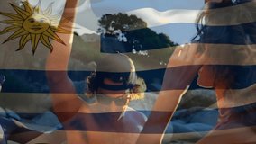 Raising red cups outdoors, people celebrating with Uruguay flag animation overhead. Celebration, togetherness, joy, festival, national, unity - Powered by Shutterstock - Get 15% off with code: PIKWIZARD15