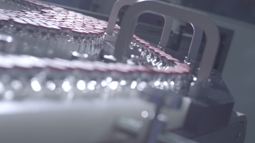 real shot of injection vial filling production line in a biopharmaceutical factory