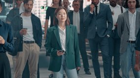 Diverse Group of Multiethnic Men and Women Standing on a Red Light. People Starting to Cross the Street When Light Turns Green. Asian Woman Using Smartphone, Muslim Female Wearing a Hijab - Powered by Shutterstock - Get 15% off with code: PIKWIZARD15