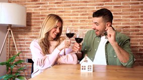  Two happy adults, toasting the purchase of the new house, with red wine. - Powered by Shutterstock - Get 15% off with code: PIKWIZARD15