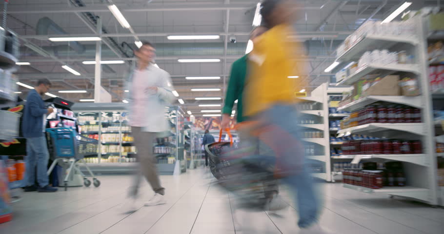 Timelapse with a Mix of Shoppers from Young Couples to Families Navigate the Aisles of a Supermarket. People Selecting Fresh Produce, Comparing Labels and Grabbing Discounts on Their Favorite Items