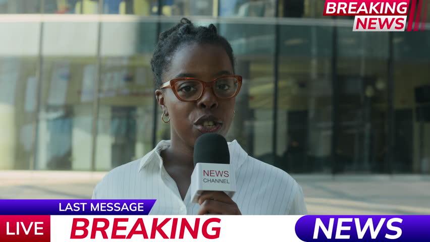 Chest up shot of young Black female reporter in eyeglasses delivering breaking news for TV programme in microphone while standing in street against tall glass office building at daytime